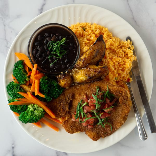 Lincoln Grill Cafe's breaded steak with rice, black beans, plantains, broccoli, and carrots.
